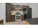 Stylish kitchen features stainless steel appliances, tile backsplash, and dark cabinets at 2328 Fossil Canyon Dr, Henderson, NV 89052