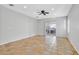 Spacious living room featuring neutral paint and large tile floors and a ceiling fan at 2328 Fossil Canyon Dr, Henderson, NV 89052