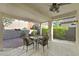 Relaxing covered patio with a dining set and view of landscaped backyard at 2328 Fossil Canyon Dr, Henderson, NV 89052