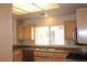 Traditional kitchen featuring stainless steel appliances and wood cabinets under a fluorescent light at 3001 Anna Bay Dr, Las Vegas, NV 89134
