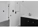 A bathroom showcasing a black vanity, sink and faucet with white walls at 3217 Harbor Vista St, Las Vegas, NV 89117