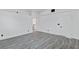 Bedroom with gray wood-look floors, white walls, en suite bathroom and walk-in closet at 3217 Harbor Vista St, Las Vegas, NV 89117