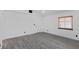 Bedroom with gray wood-look floors, white walls, and a window with wood blinds at 3217 Harbor Vista St, Las Vegas, NV 89117