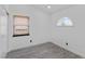 Bedroom with gray wood-look floors, white walls, and arched window at 3217 Harbor Vista St, Las Vegas, NV 89117