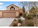 Inviting home with desert landscaping, arched entryway and a two-car garage at 3217 Harbor Vista St, Las Vegas, NV 89117
