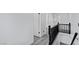 Hallway with gray wood-look floors, white walls, white doors and black trim at 3217 Harbor Vista St, Las Vegas, NV 89117