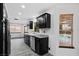 Kitchen featuring dark cabinets, stainless appliances, granite counters, and an outdoor pool view at 3217 Harbor Vista St, Las Vegas, NV 89117