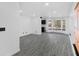 Spacious living room featuring gray wood floors, white walls, and abundant natural light at 3217 Harbor Vista St, Las Vegas, NV 89117