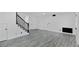 Living room featuring wood-look flooring, neutral walls, staircase and access to other rooms at 3217 Harbor Vista St, Las Vegas, NV 89117