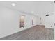 Open-concept living room featuring light gray wood floors, neutral walls, and plenty of natural light at 3217 Harbor Vista St, Las Vegas, NV 89117
