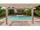 Beautiful backyard pool and spa area featuring a covered patio and lush landscaping at 3217 Harbor Vista St, Las Vegas, NV 89117