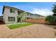 Backyard with artificial turf, gravel, a privacy fence, and the exterior of the home at 3760 Paseo De Paz Ave, Las Vegas, NV 89115