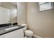 Bathroom with sleek vanity, black countertop, and contemporary fixtures at 3760 Paseo De Paz Ave, Las Vegas, NV 89115