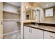 Bathroom featuring a vanity with double sinks and a walk-in closet providing plenty of storage at 3760 Paseo De Paz Ave, Las Vegas, NV 89115