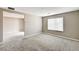 Neutral bedroom with carpet and a window, with an open doorway to another room at 3760 Paseo De Paz Ave, Las Vegas, NV 89115