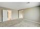 Bright bedroom with neutral walls and carpet, multiple doorways offering flexible layout options at 3760 Paseo De Paz Ave, Las Vegas, NV 89115