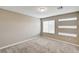 This bedroom has carpeted floors and multiple windows with white blinds at 3760 Paseo De Paz Ave, Las Vegas, NV 89115