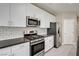 Modern kitchen with stainless steel appliances, stylish backsplash and ample counter space at 3760 Paseo De Paz Ave, Las Vegas, NV 89115