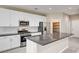 Modern kitchen with stainless steel appliances, subway tile backsplash, and island with bar seating at 3760 Paseo De Paz Ave, Las Vegas, NV 89115
