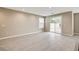 Living room area featuring tile floors, window, and sliding glass door leading to the back patio at 3760 Paseo De Paz Ave, Las Vegas, NV 89115
