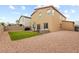Manicured backyard featuring an artificial grass lawn, outdoor seating area and gravel ground cover at 4039 Beech Fern Ave, North Las Vegas, NV 89084