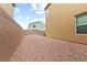 Desert landscaped backyard area with gravel ground cover and a block wall at 4039 Beech Fern Ave, North Las Vegas, NV 89084