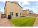 Backyard featuring an artificial grass lawn, patio, gravel ground cover and BBQ area at 4039 Beech Fern Ave, North Las Vegas, NV 89084