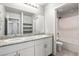 Bright bathroom boasts double sinks with granite countertops and a shower-over-tub combo at 4039 Beech Fern Ave, North Las Vegas, NV 89084