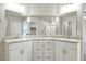 Bathroom featuring double sinks, vanity with drawers, and large mirrors at 4039 Beech Fern Ave, North Las Vegas, NV 89084