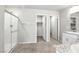Modern bathroom with tiled flooring, granite countertops, double sinks, and a glass-enclosed shower at 4039 Beech Fern Ave, North Las Vegas, NV 89084