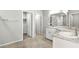 Bathroom featuring tiled floors, granite countertops, double sinks, a large mirror, and a walk-in shower at 4039 Beech Fern Ave, North Las Vegas, NV 89084