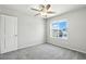 Bright bedroom with a window view, gray carpet, and white door for entry at 4039 Beech Fern Ave, North Las Vegas, NV 89084