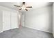 This bedroom includes gray carpet and a closet with sliding doors for storage at 4039 Beech Fern Ave, North Las Vegas, NV 89084