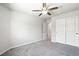 A simple bedroom includes gray carpet and a closet with sliding doors for storage at 4039 Beech Fern Ave, North Las Vegas, NV 89084