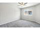 A simple bedroom features gray carpet and a bright window allowing natural light at 4039 Beech Fern Ave, North Las Vegas, NV 89084