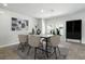 Bright dining room with modern decor, stylish table setting, and view to green space at 4039 Beech Fern Ave, North Las Vegas, NV 89084