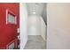 Inviting foyer with tile flooring, a modern red door, and access to the staircase at 4039 Beech Fern Ave, North Las Vegas, NV 89084