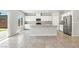 Modern, bright kitchen featuring stainless appliances, granite counters and island, and outdoor access at 4039 Beech Fern Ave, North Las Vegas, NV 89084