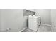 Functional laundry room featuring modern washer and dryer units and convenient upper shelving at 4039 Beech Fern Ave, North Las Vegas, NV 89084