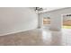 Bright living room with tiled floors, ceiling fan, and sliding glass door leading to the backyard at 4039 Beech Fern Ave, North Las Vegas, NV 89084