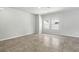 Bright, spacious living room featuring neutral walls and tiled flooring with natural light from large windows at 4039 Beech Fern Ave, North Las Vegas, NV 89084