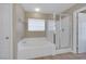 Bright bathroom boasts a separate tub and shower with glass doors, and a large, neutral color scheme at 4225 Telstar Ct, North Las Vegas, NV 89032