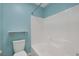 Bathtub/shower combo with white tiled walls and a toilet with a shelf above it at 4225 Telstar Ct, North Las Vegas, NV 89032