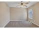 Bedroom featuring soft carpet, a ceiling fan, and a bright window, creating a comfortable and relaxing space at 4225 Telstar Ct, North Las Vegas, NV 89032