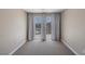 Empty bedroom featuring neutral carpet, base trim, and balcony access at 4225 Telstar Ct, North Las Vegas, NV 89032