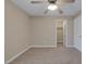 Neutral bedroom features a ceiling fan, carpeted floors, and a walk-in closet at 4225 Telstar Ct, North Las Vegas, NV 89032