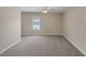 Spacious bedroom featuring neutral carpet, base trim, and natural lighting at 4225 Telstar Ct, North Las Vegas, NV 89032
