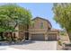 Inviting two-story home with a three-car garage and mature trees in a well-maintained neighborhood at 4225 Telstar Ct, North Las Vegas, NV 89032