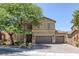 Two-story home featuring desert landscaping, two-car garage, and covered porch at 4225 Telstar Ct, North Las Vegas, NV 89032