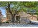 Two-story home with manicured yard, desert landscaping, and two-car garage at 4225 Telstar Ct, North Las Vegas, NV 89032